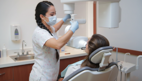 Dental Worker Positioning an X-ray Machine